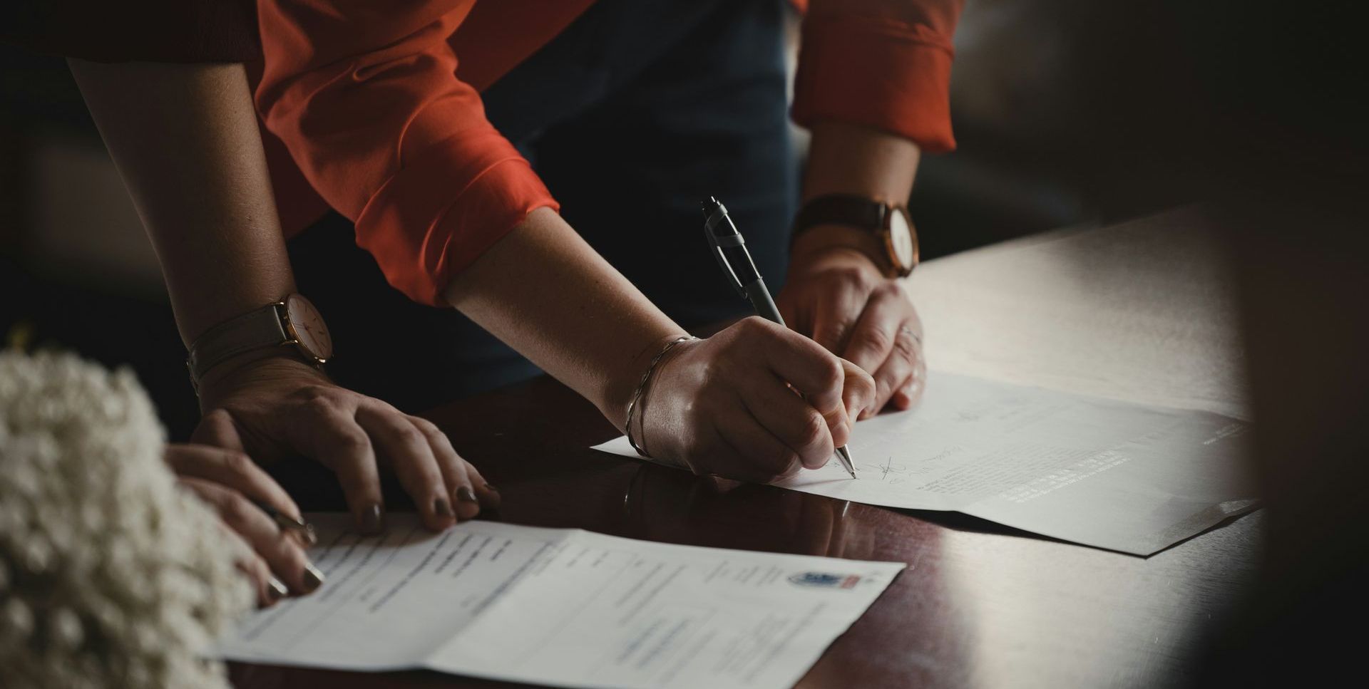 two people writing a real estate offer