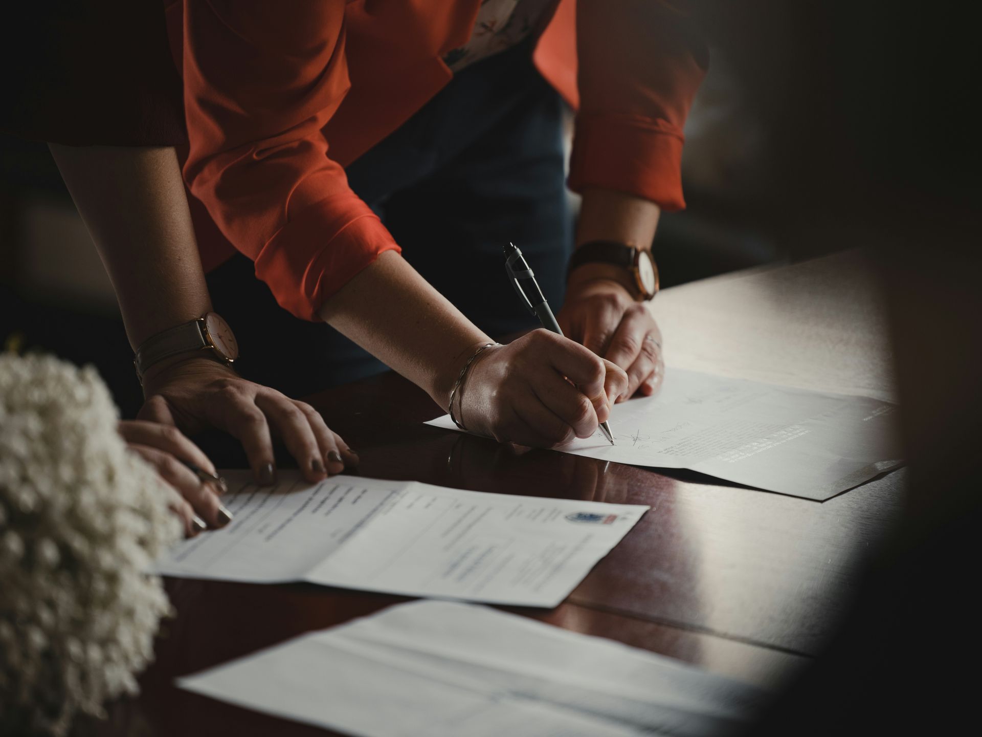 Photo of a person writing an offer - representing the topic of writing a winning real estate offer.