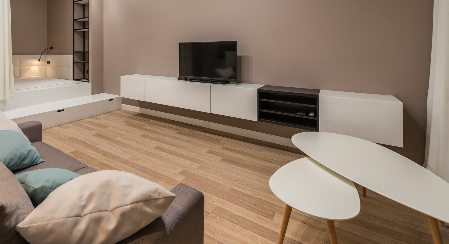 A living room with a couch , table , and television.
