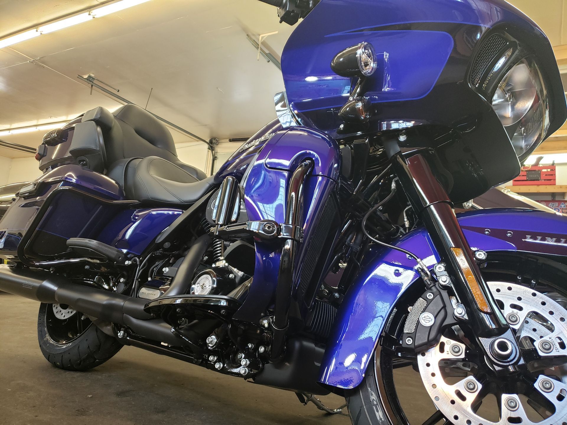 Blue and black Harley Davidson motorcycle parked indoors.