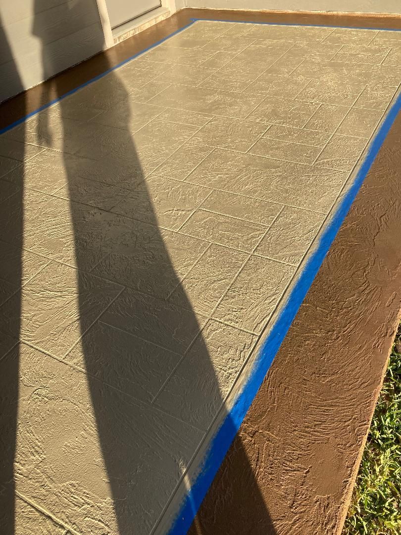Sunlit sidewalk with a blue painted line and a person's shadow cast across it.