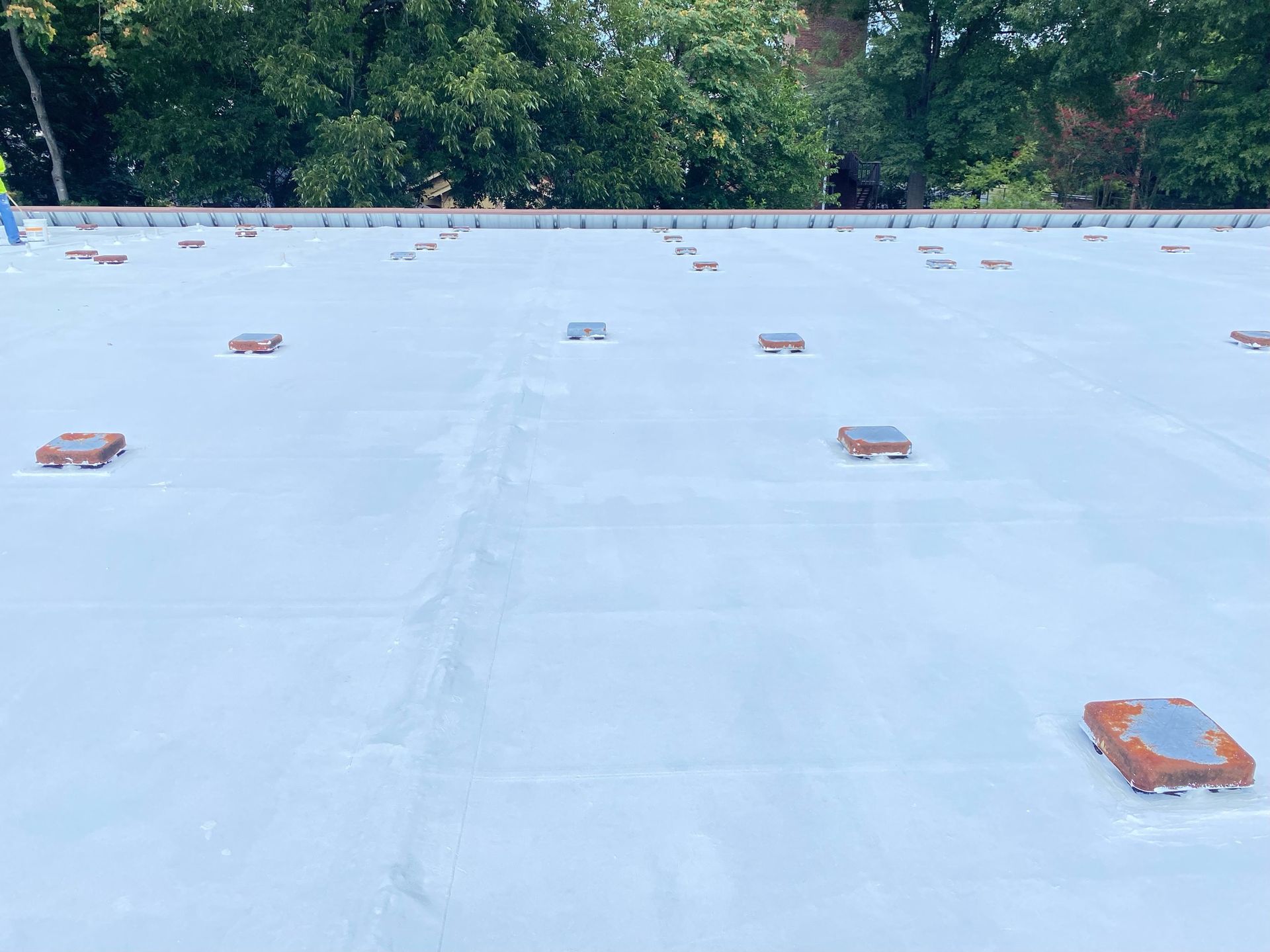Completed EPDM roof restoration with Mule-Hide acrylic coating at Carter G. Woodson School in Winston-Salem NC