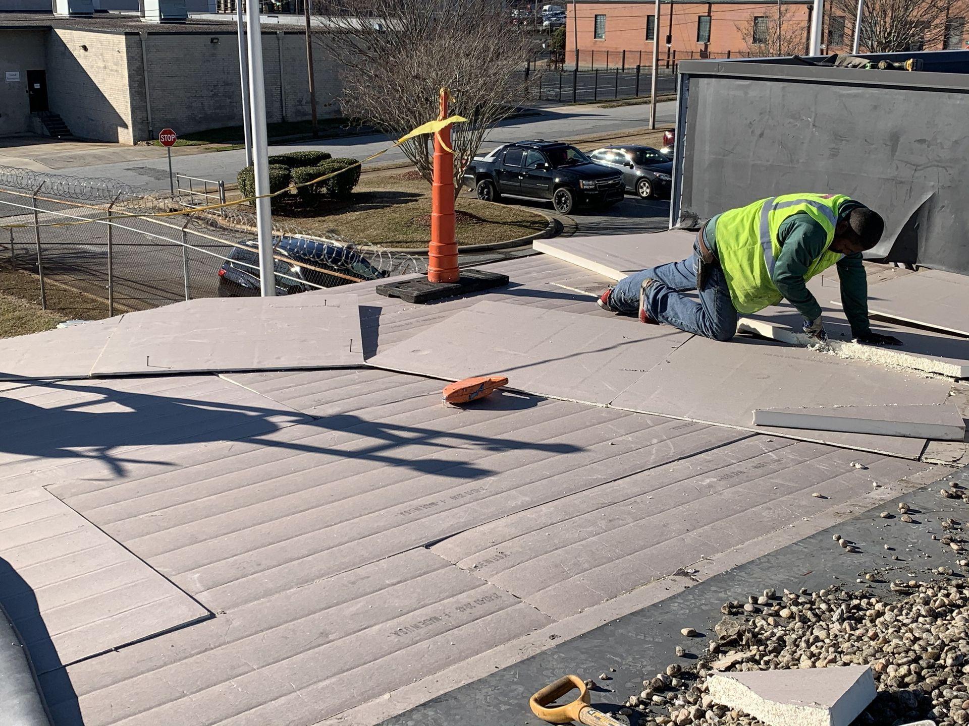 B&D Roofing Solutions crew installing polyiso roof insulation during the commercial EPDM roof replacement at the High Point Housing Authority main office in High Point, NC.