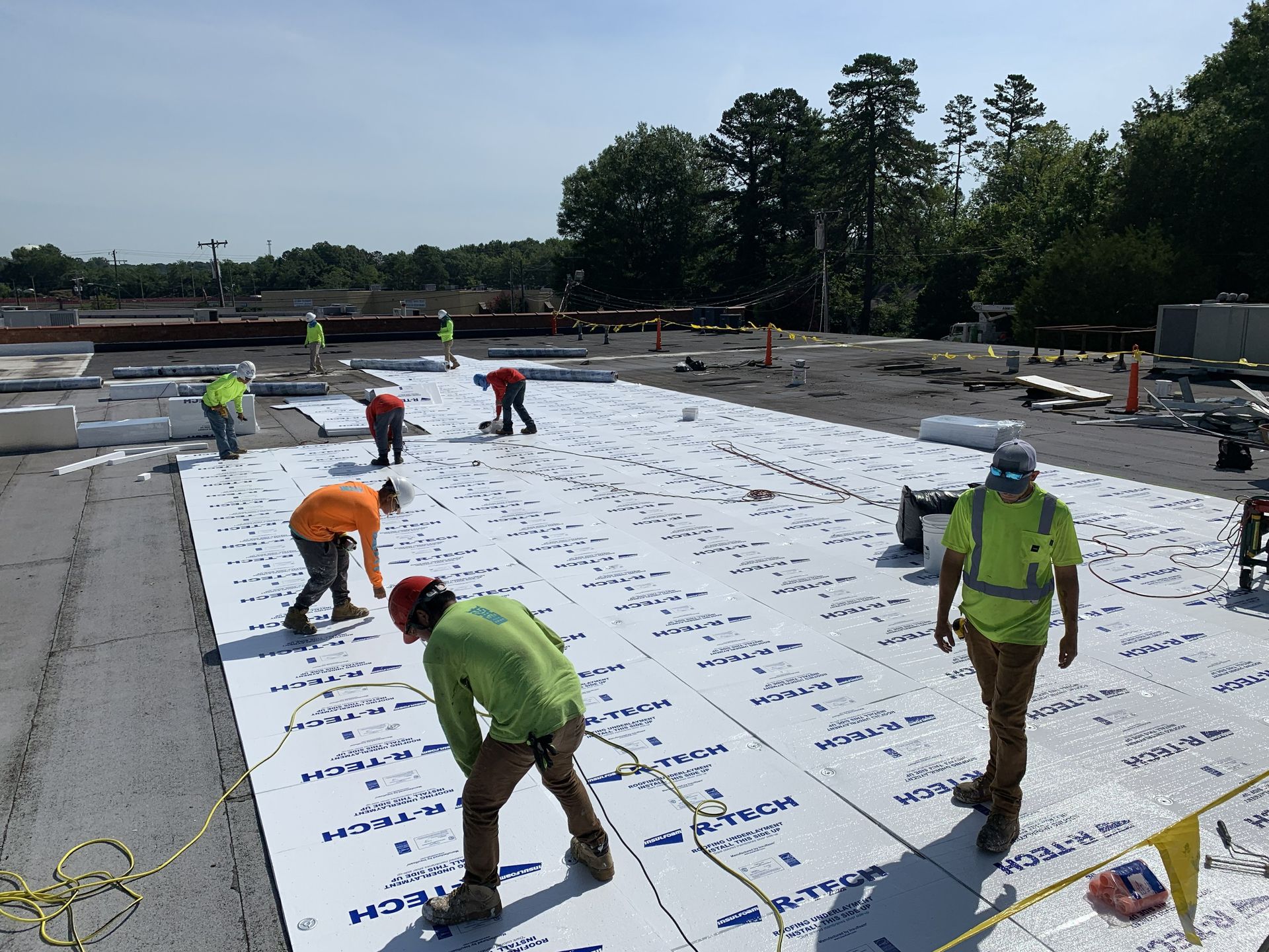 Installation of new fanfold roof insulation during the Franklin Properties commercial TPO roof recover in Greensboro, NC, by B&D Roofing Solutions.