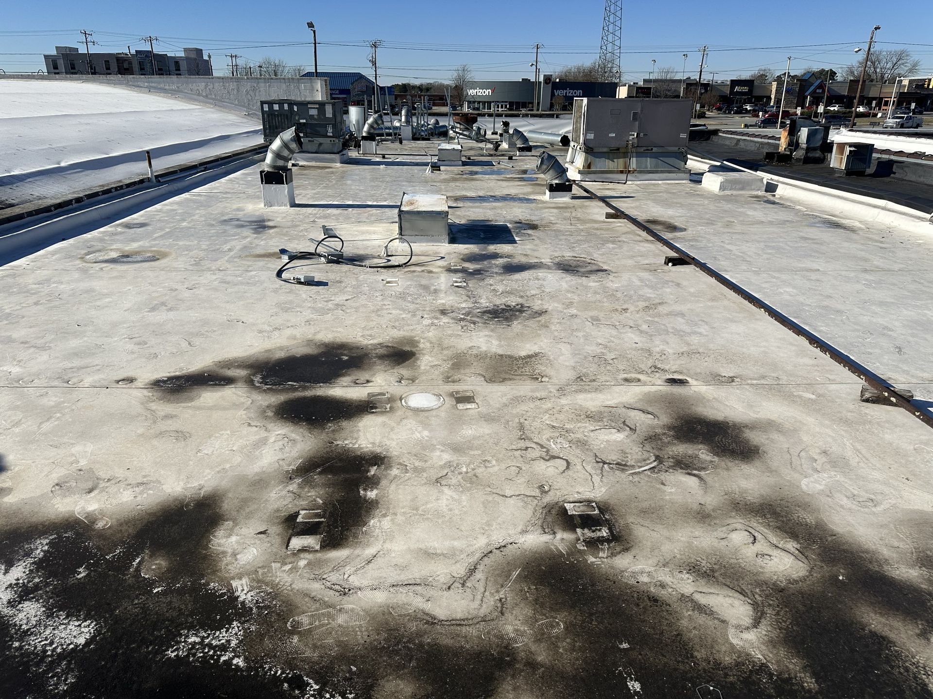 Existing commercial roofing system before partial tear-off and Carlisle TPO roof recover by B&D Roofing Solutions at Franklin Properties on Lawndale Drive in Greensboro, NC.