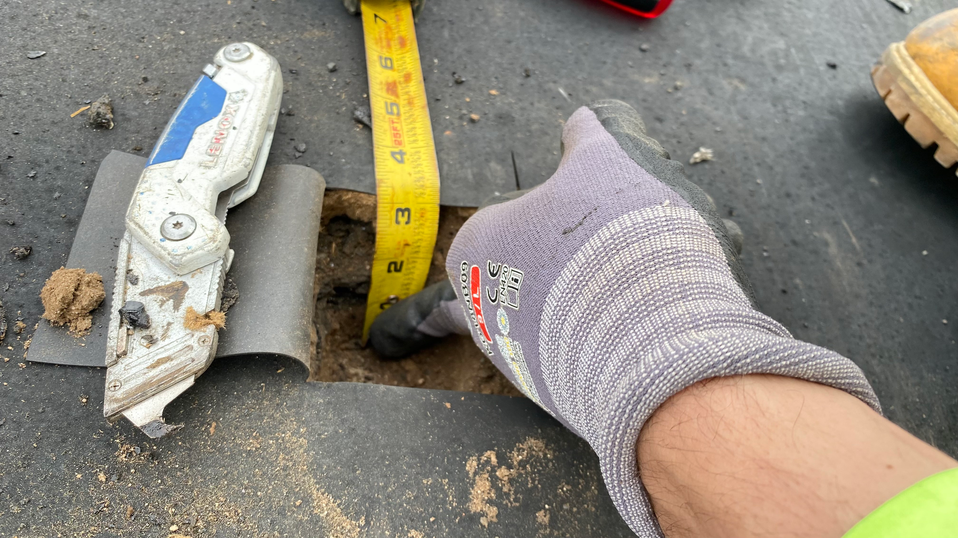 Commercial roof core sample showing insulation thickness during a roof restoration evaluation.