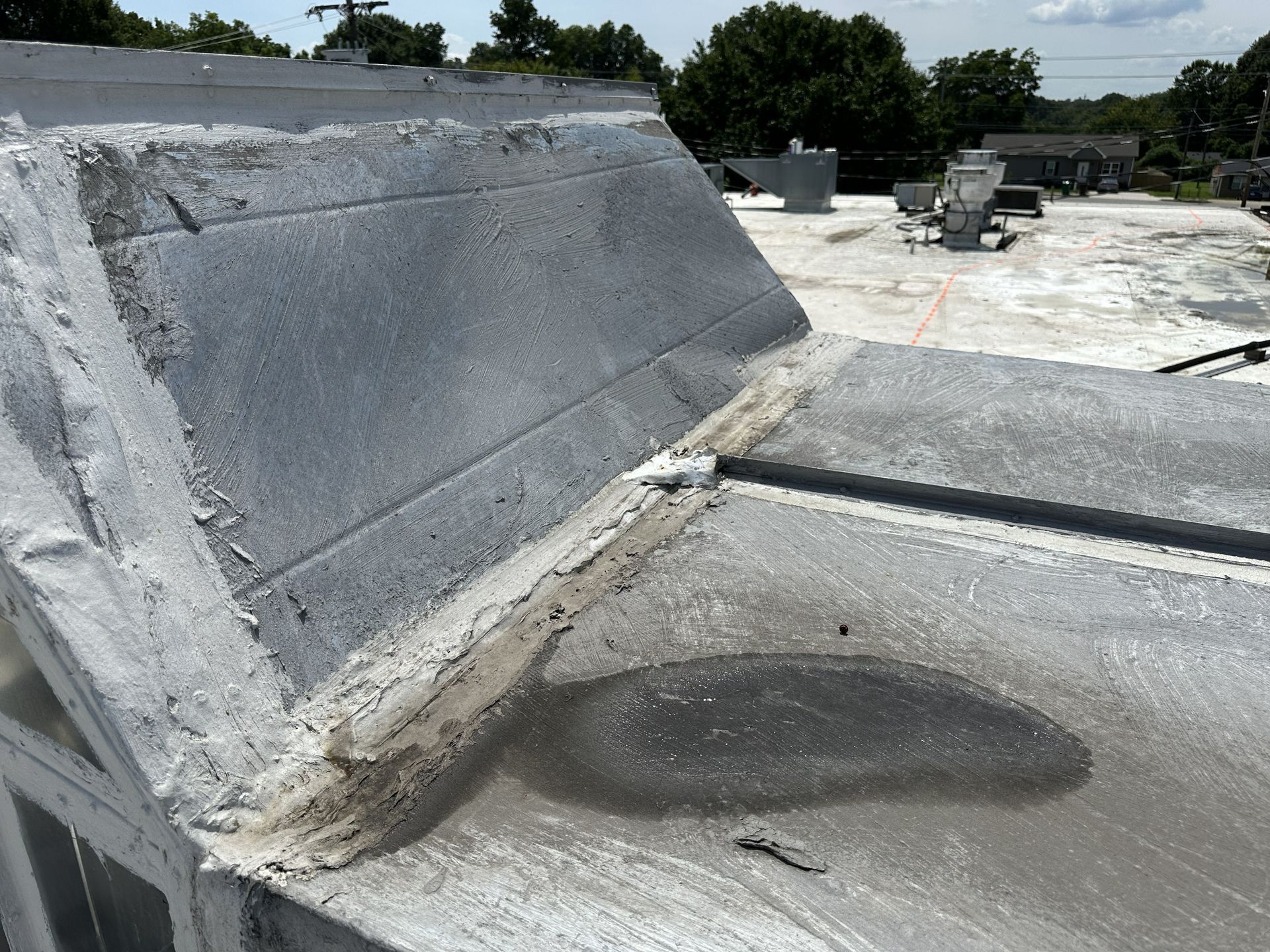 Commercial roof and rooftop HVAC equipment during a water intrusion evaluation.
