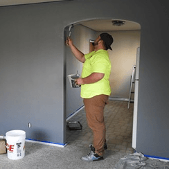 man applying paint