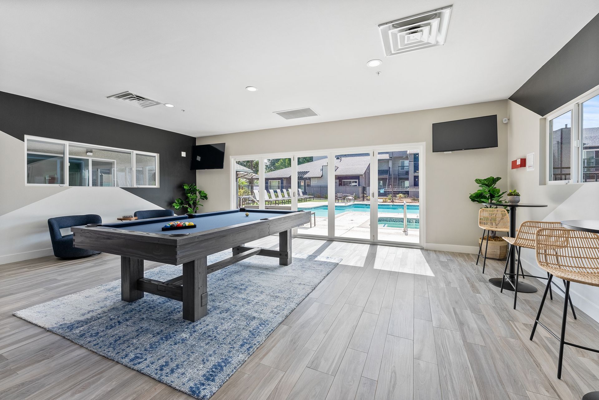 There is a pool table in the middle of the room.