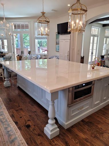 There is a large island in the middle of the kitchen.