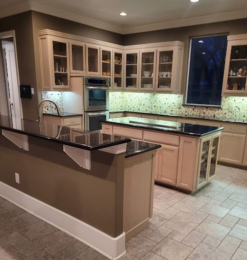 A kitchen with a large island and lots of cabinets