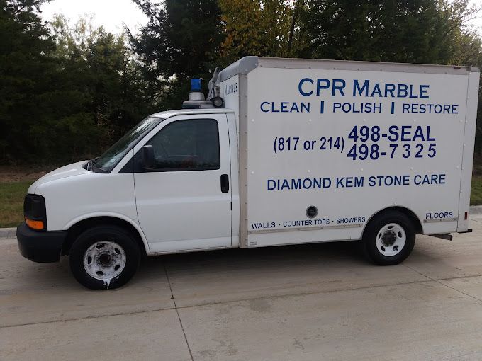 A white cpr marble truck is parked on the side of the road