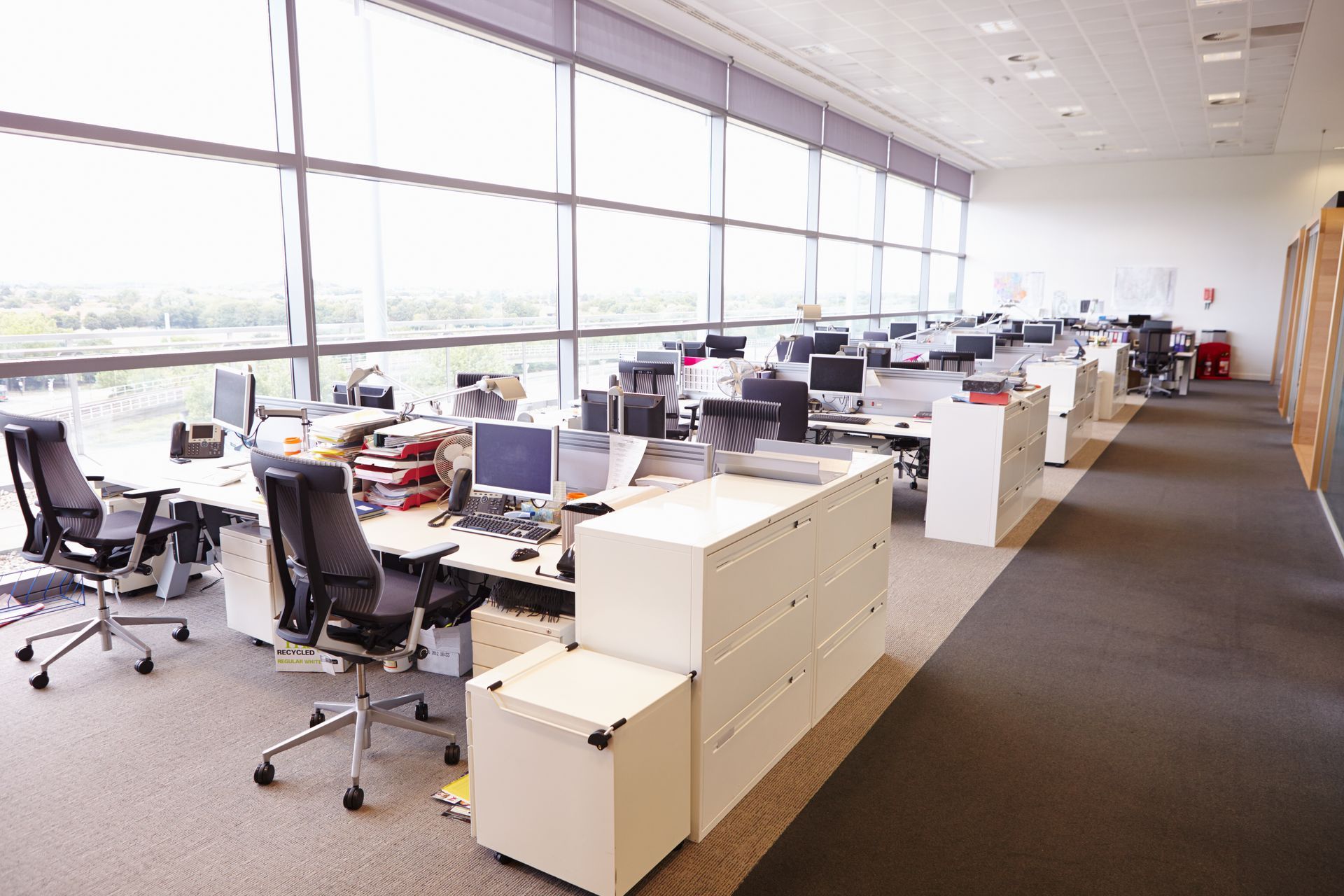 Un grand bureau vide avec beaucoup de bureaux et de chaises