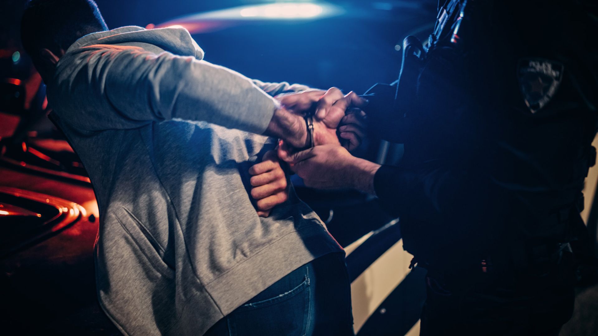 The police handcuff a man.