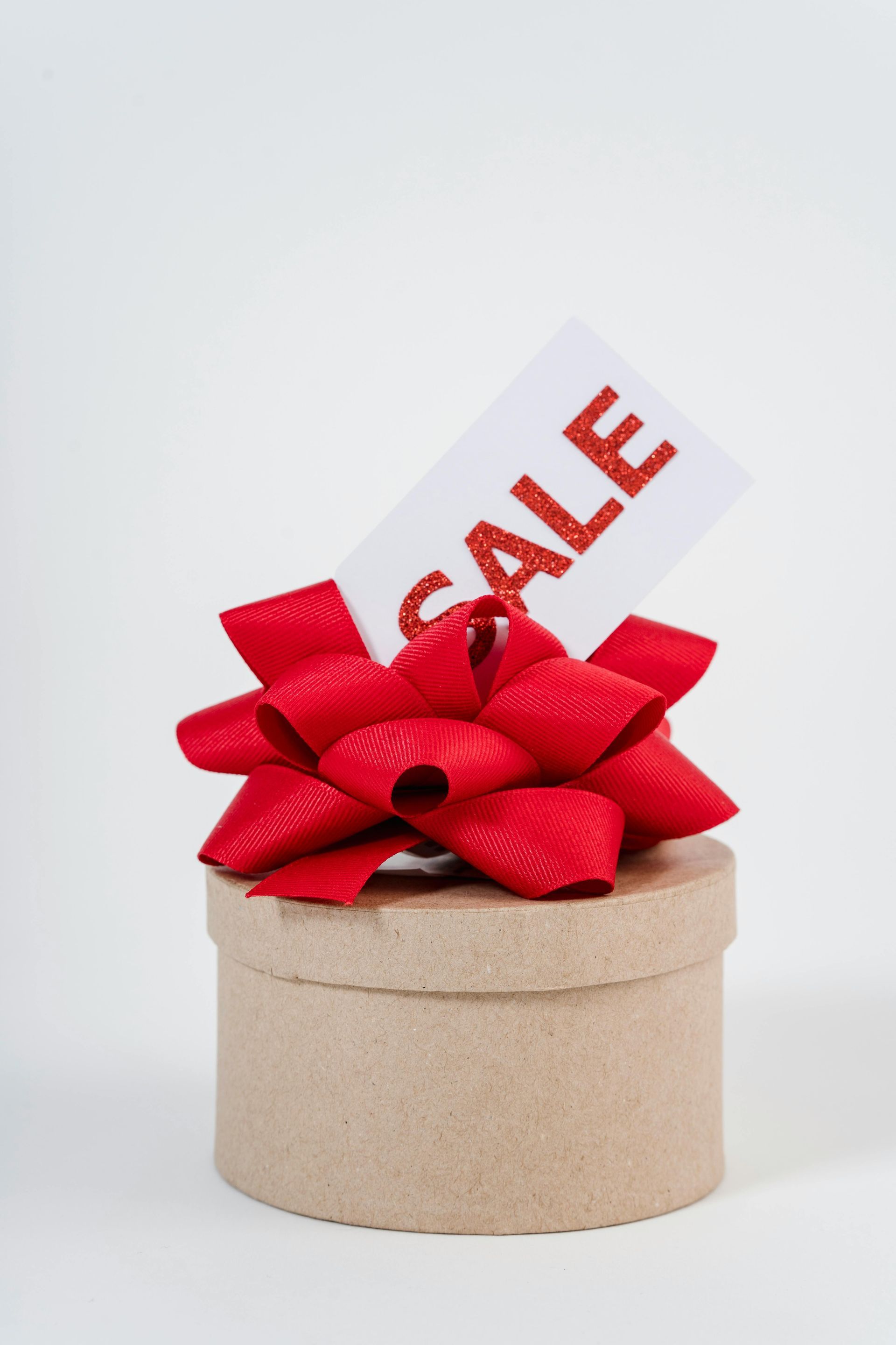 The word summer sale is written in the sand on a beach.