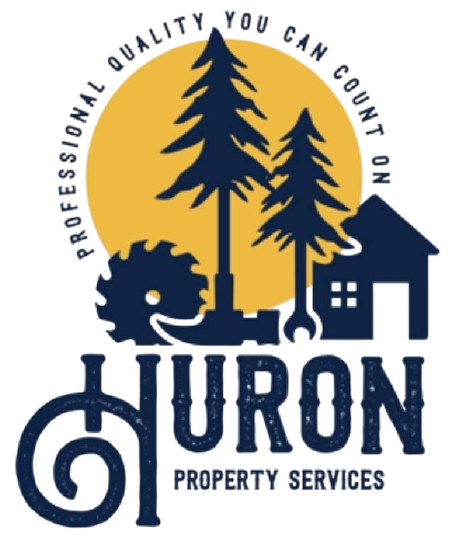 Huron Property Services logo with pine trees, house, and navy-blue lettering on a gold circle