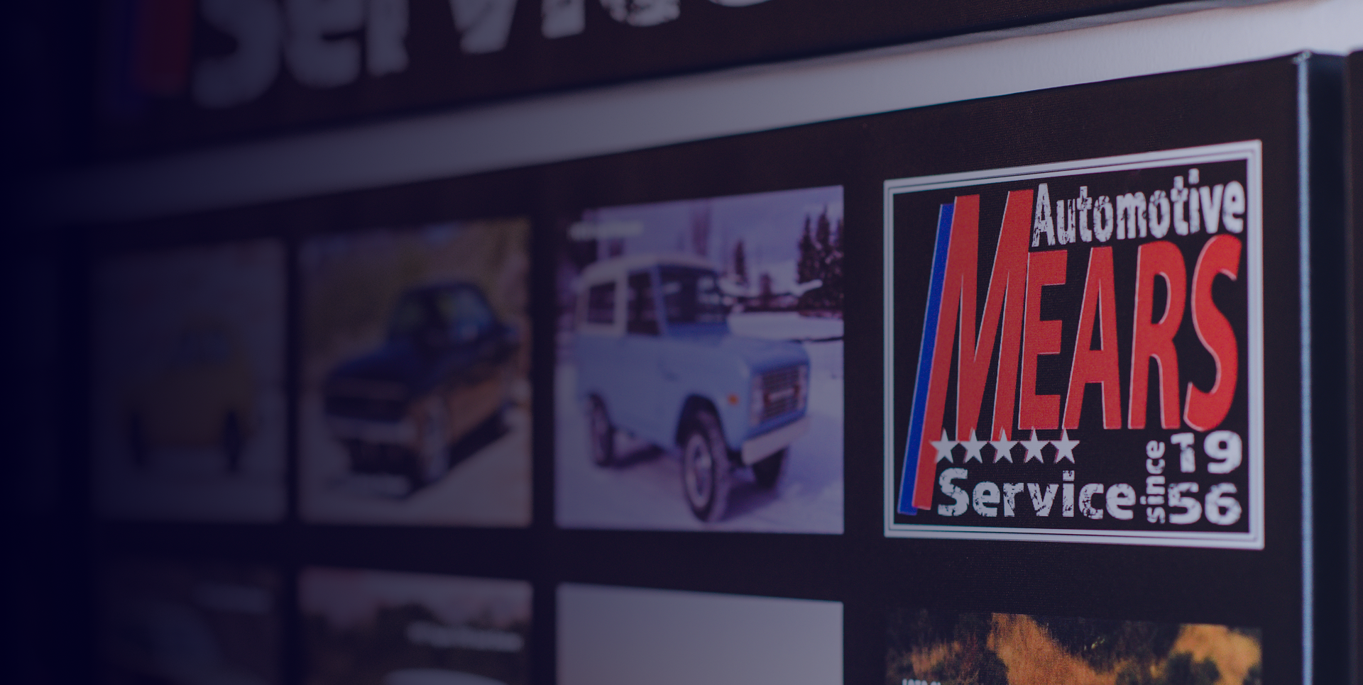 Vintage auto shop sign reading “Automotive Mears Service” with a blue classic car nearby | Mears Automotive