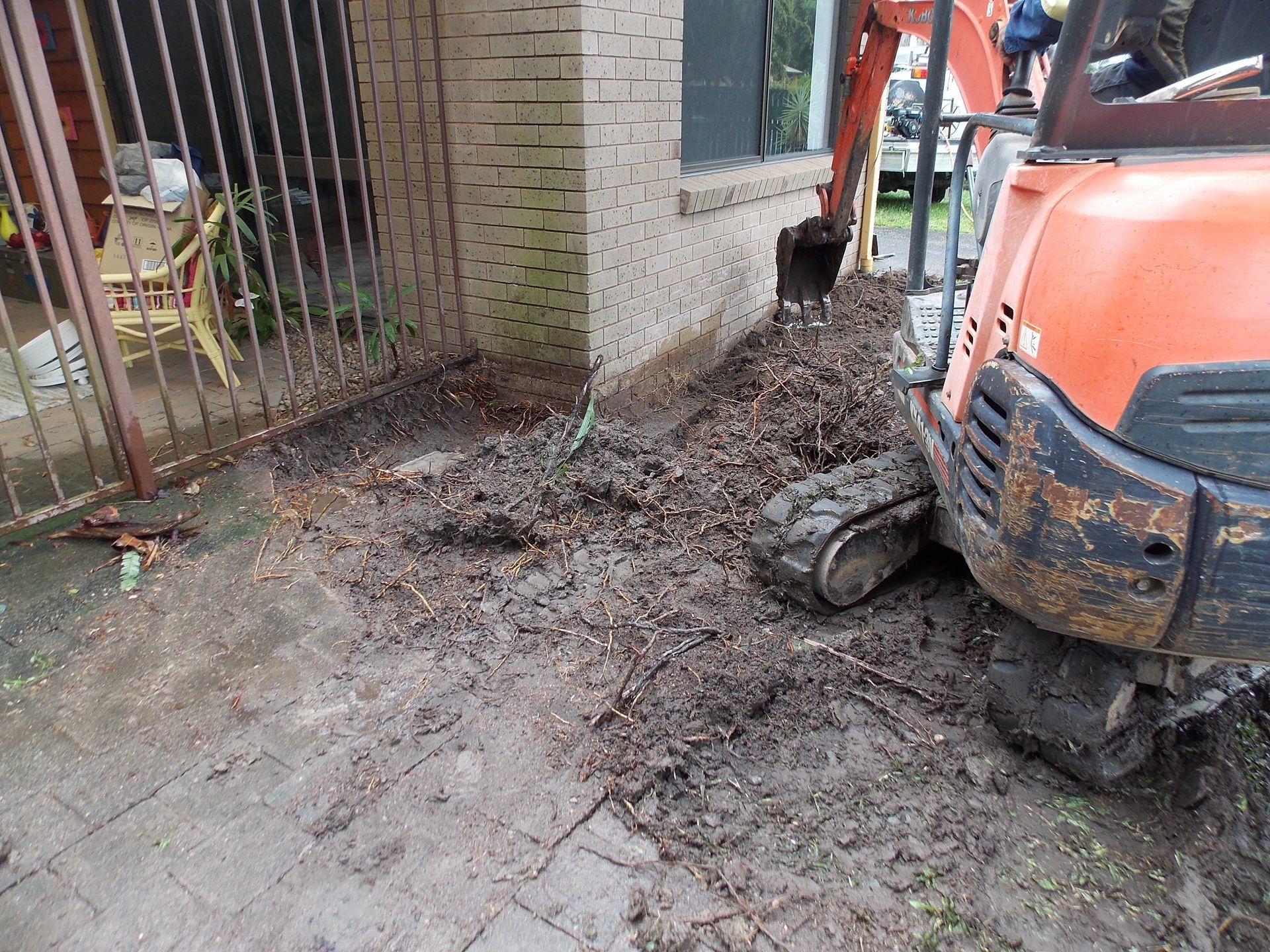 Trenches are dug around house to inject chemical to control termites in cairns