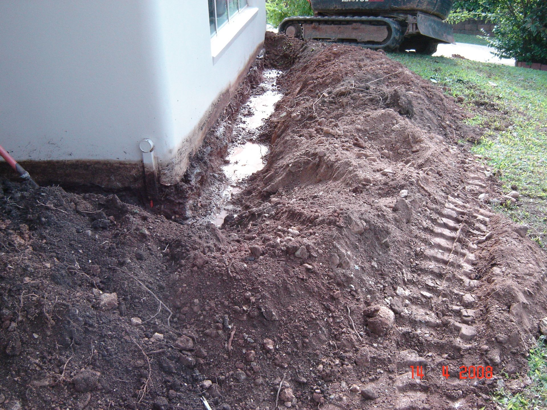trench to house perimeter to apply chemical to control termites