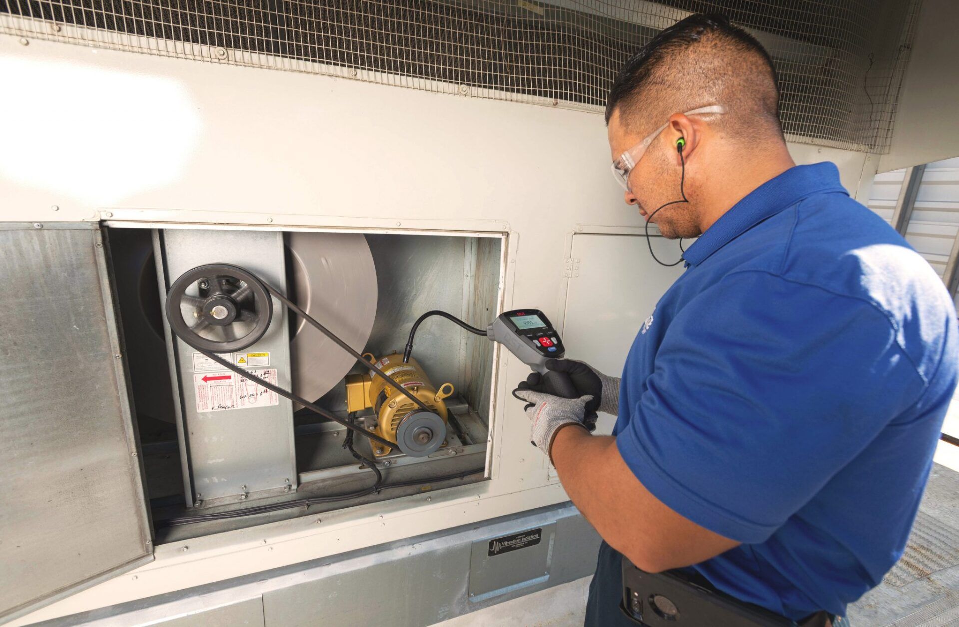 Technician inspecting HVAC equipment - DST Maximize Resources