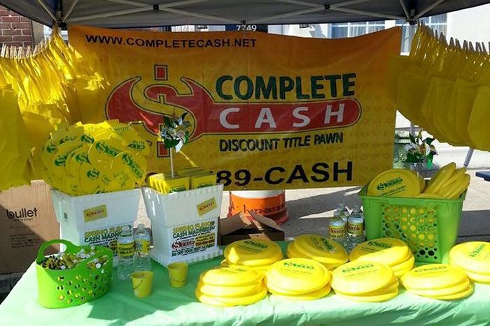 Complete Cash discount tire pawn booth with green baskets and yellow products on display