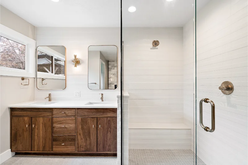 Modern bathroom with a glass shower and wood vanity.
