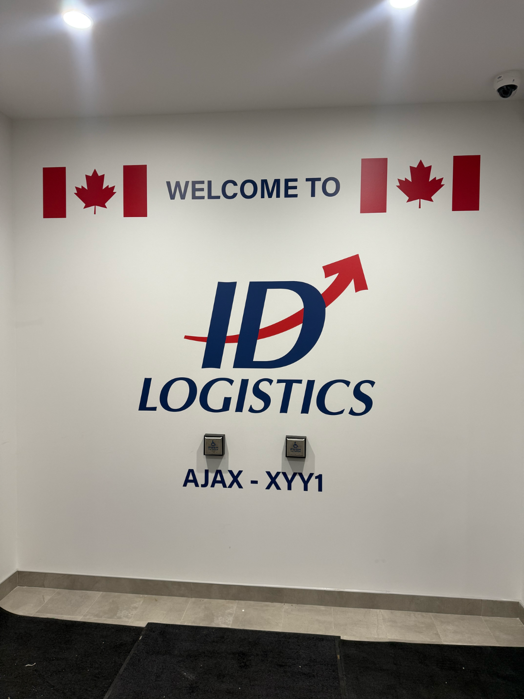 ID Logistics welcome sign in Canada with Canadian flags.