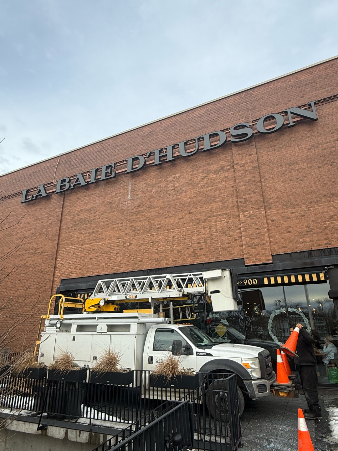 Truck with a lift near a brick building with 