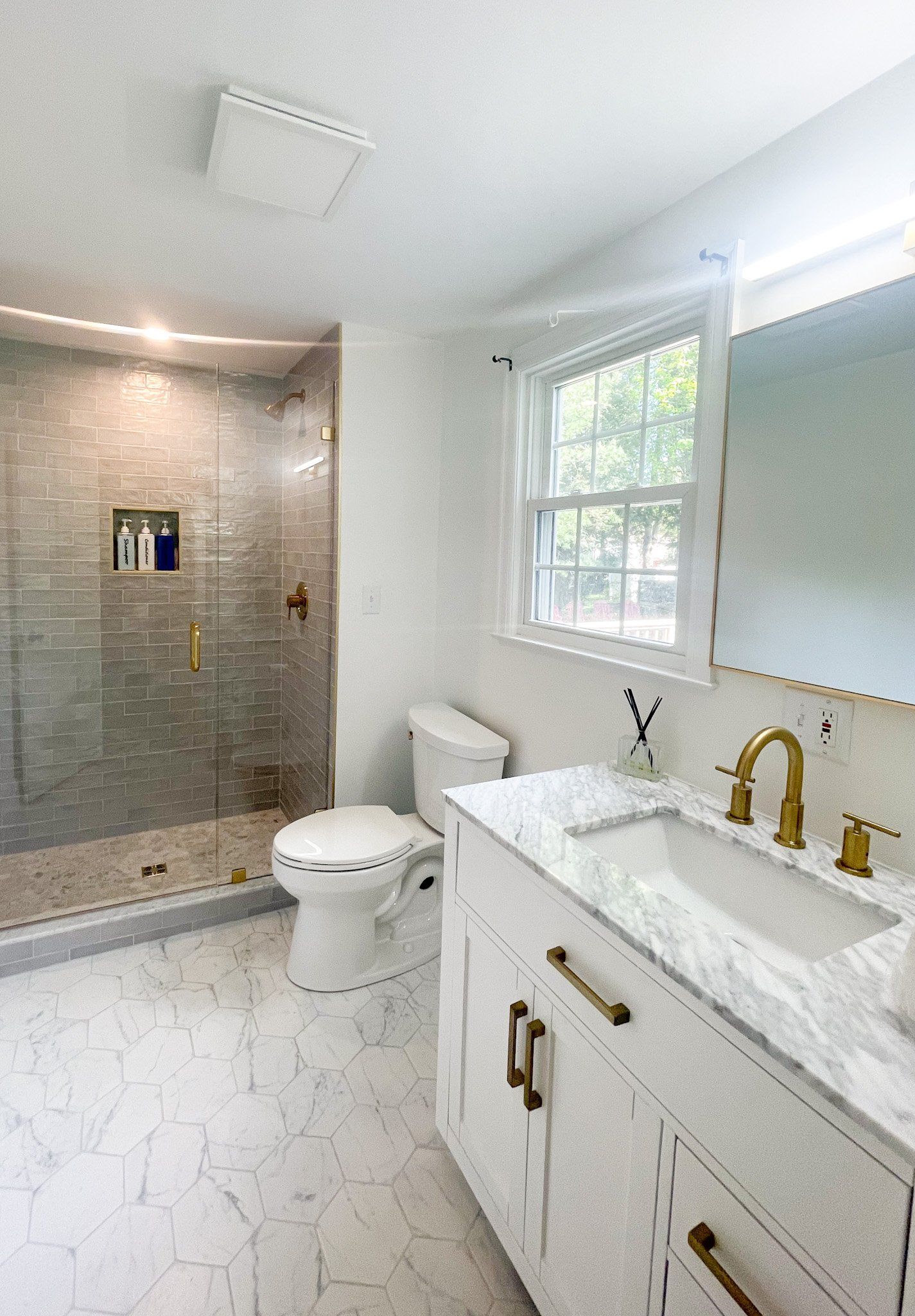 A bathroom with a toilet , sink , and shower.