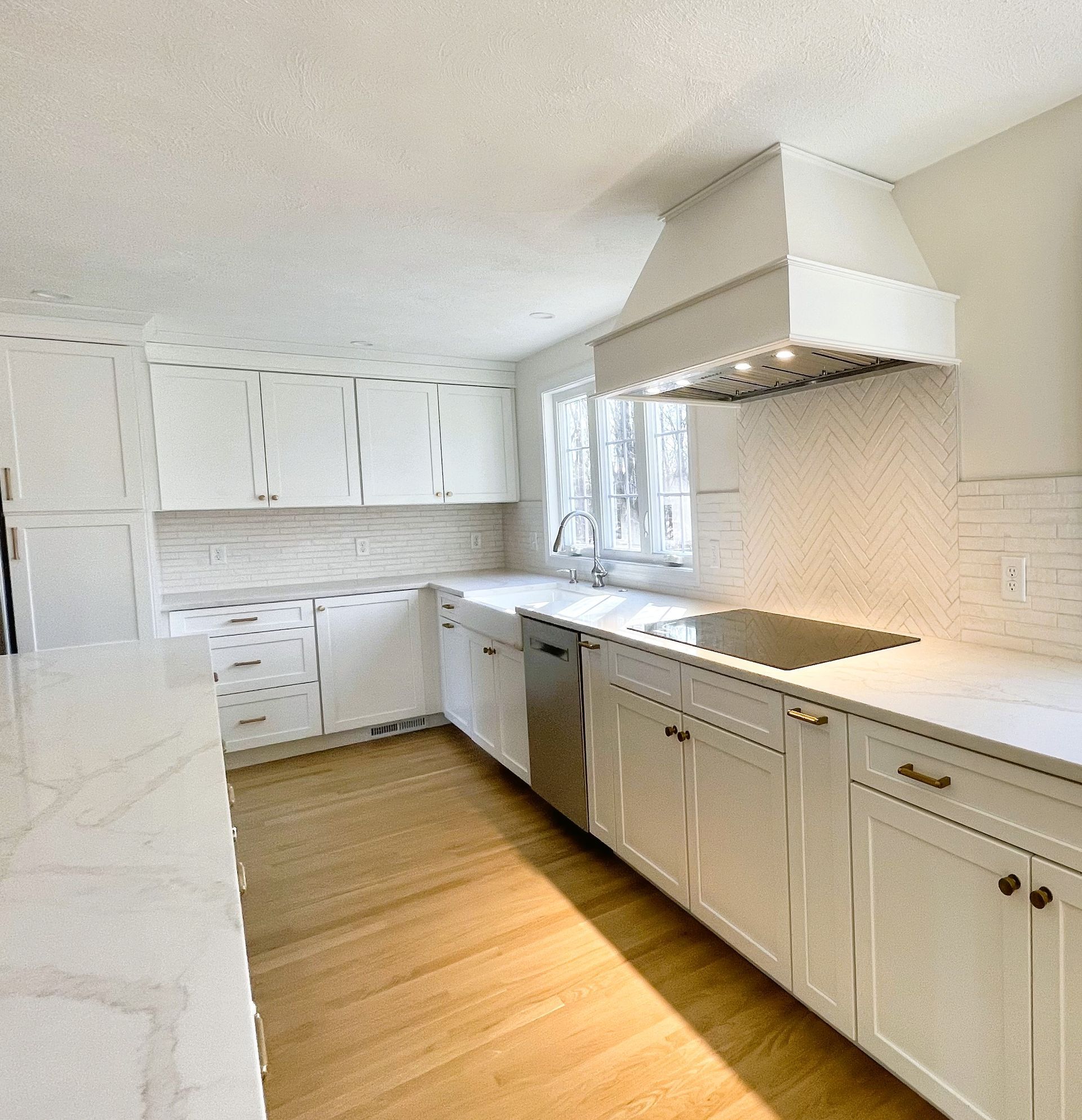 A kitchen with white cabinets and stainless steel appliances