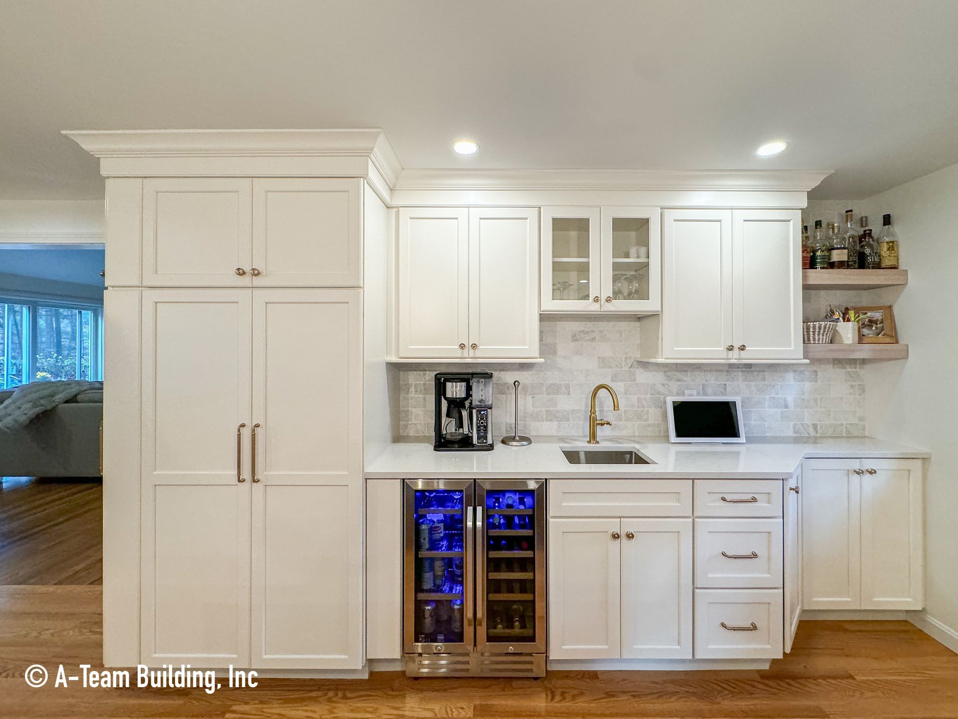 White kitchen with cabinets, wine fridge, coffee maker, sink, and under-cabinet lighting