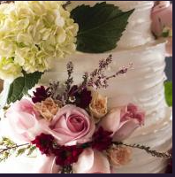 Floral wedding cake with pink and cream roses and white icing