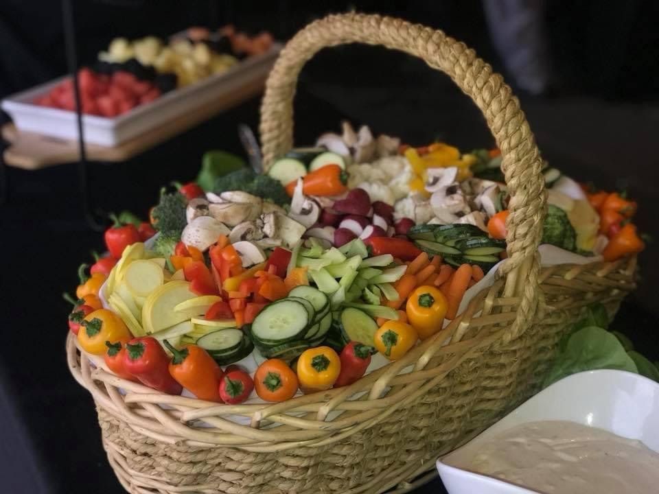 Basket of colorful vegetables and mushrooms at a buffet