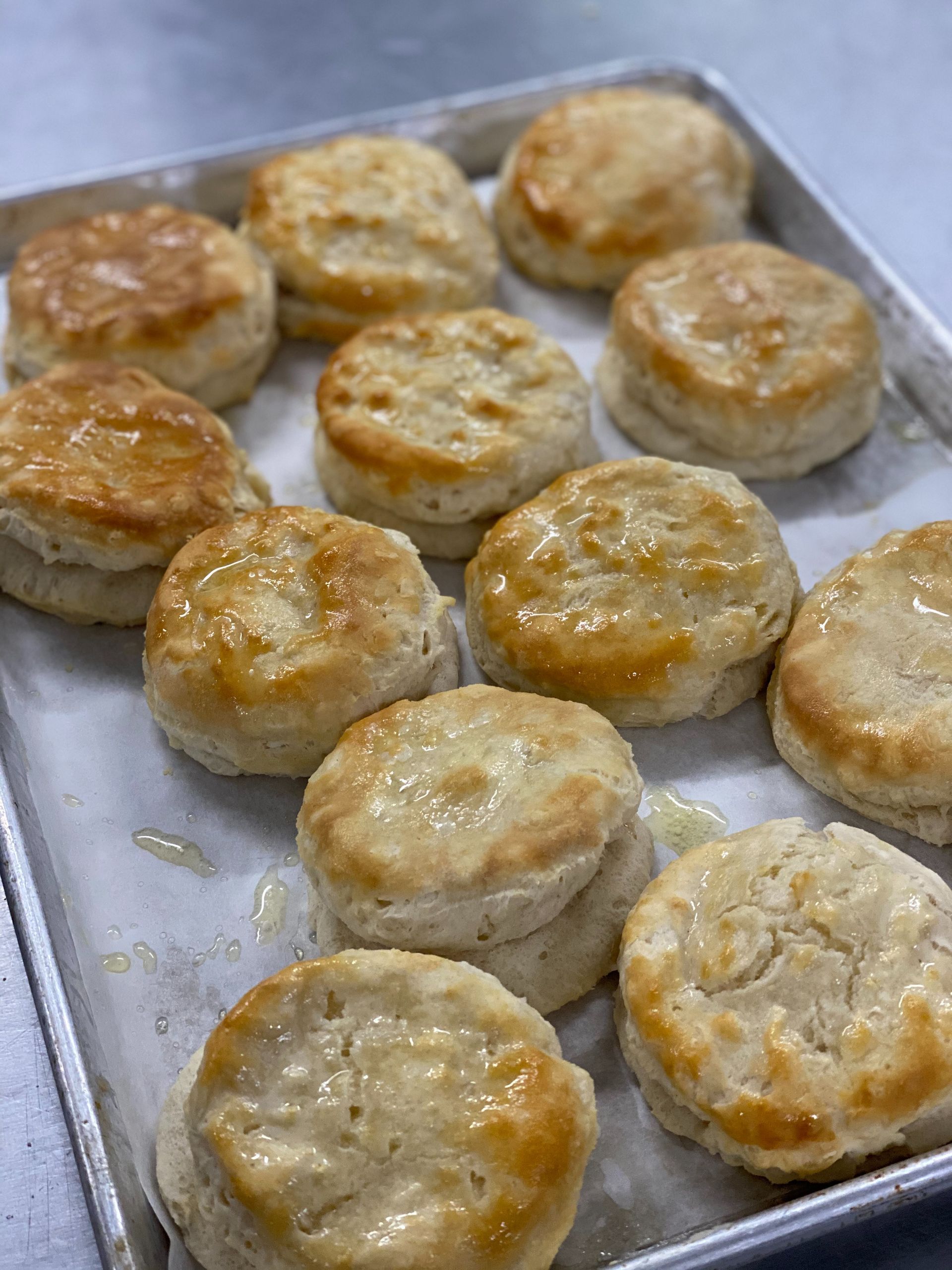 Glazed biscuits baking on a metal sheet tray