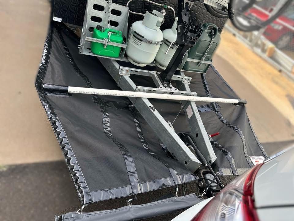 Black awning with metal propane tanks, mounted on a trailer hitch — Western Tarps and Motor Trimming In Dubbo, NSW