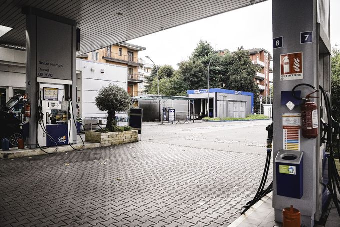 Autolavaggio Joel con un'auto nera, edifici e una persona a Milano