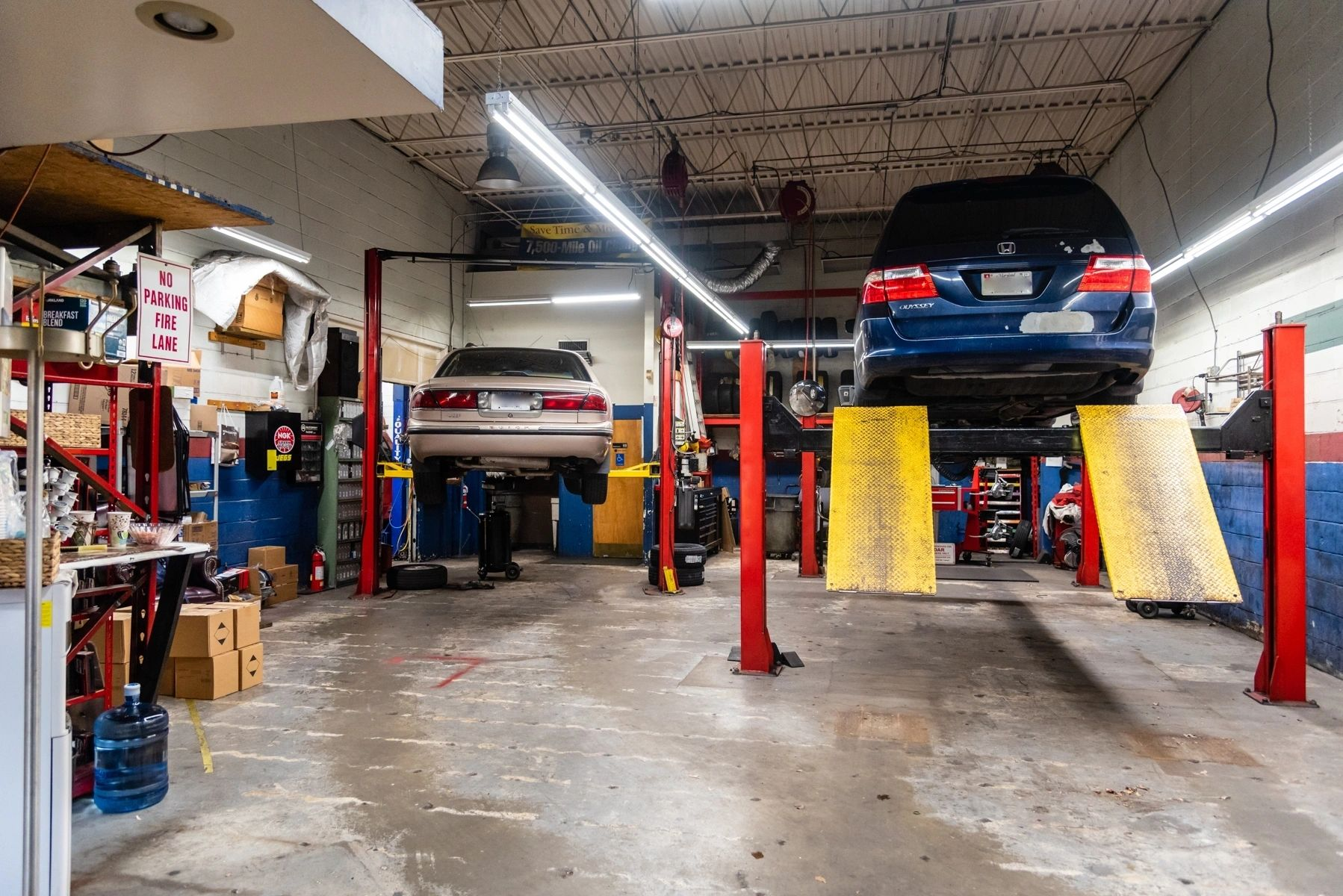 A car is sitting on a lift in a garage. | Van Dorn Auto Repair