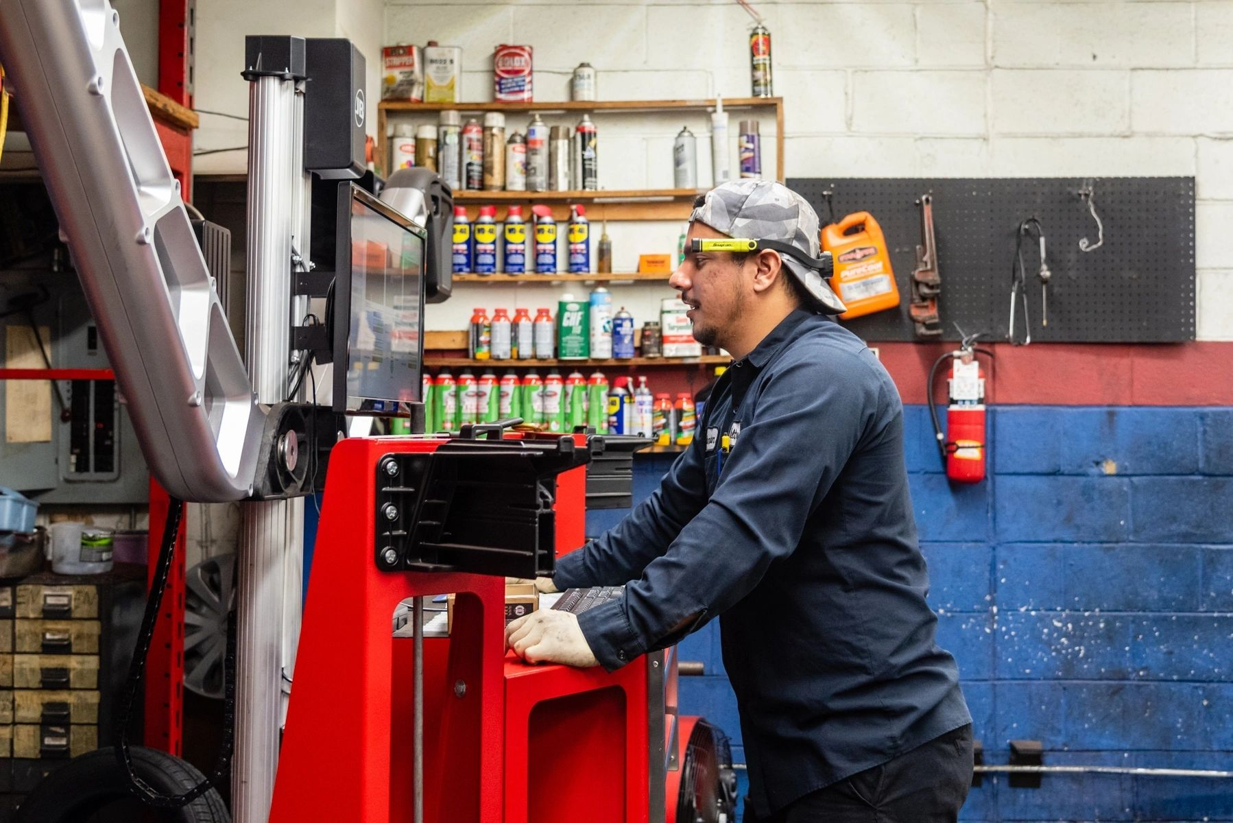 A man is working on a machine in a garage. | Van Dorn Auto Repair