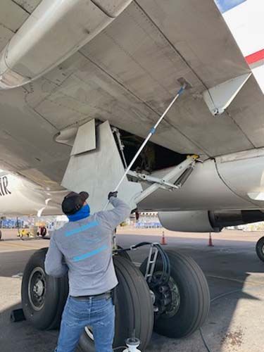 man cleaning airplane