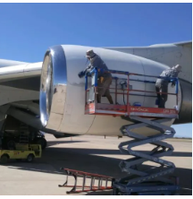 man cleaning airplane engine