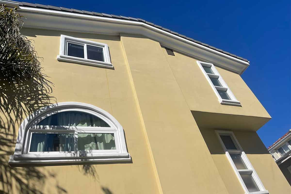 a yellow building with a blue sky in the background