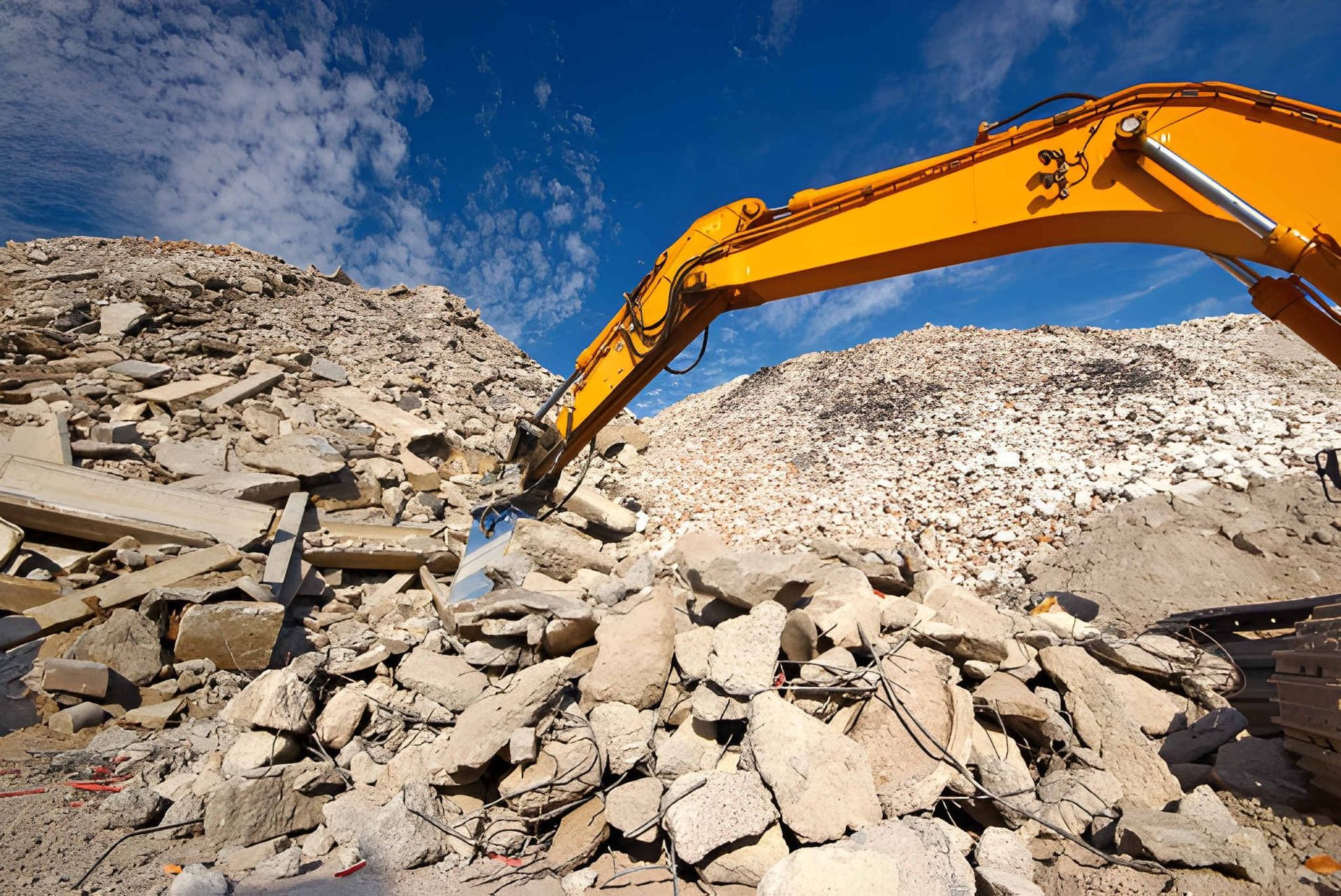 Excavator Digging Through Rubble — A & S Cuthel Earthmoving & Transport in Bellingen, NSW