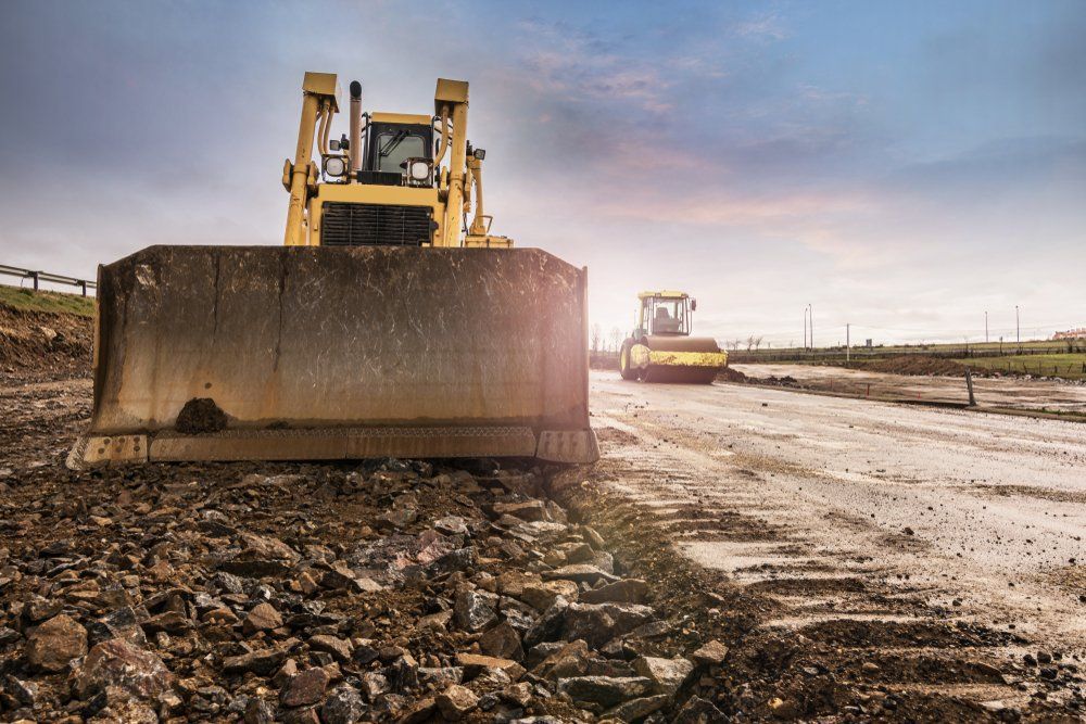 Two Bulldozers on a Muddy Construction Site — A & S Cuthel Earthmoving & Transport in Dorrigo, NSW