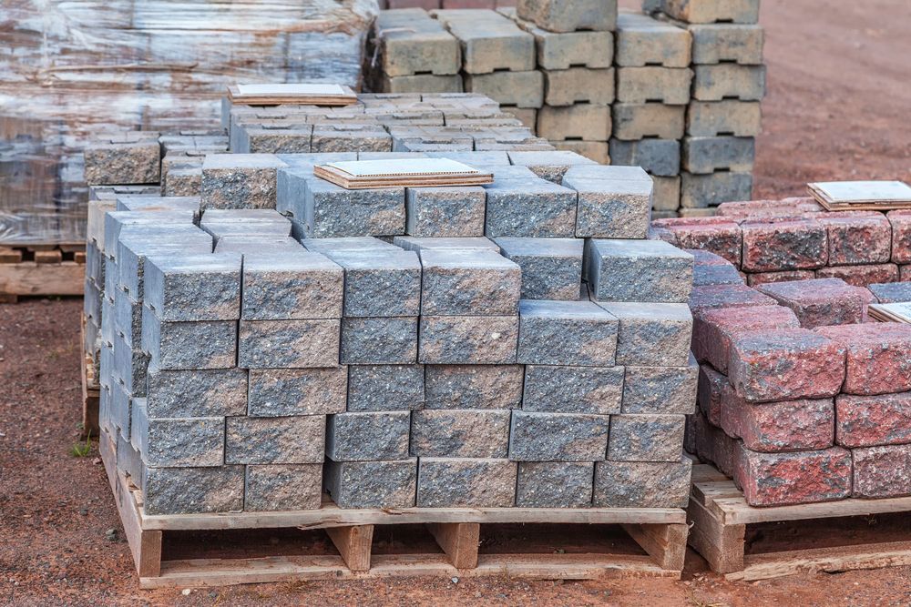Pallets Stacked With Grey and Red Paving Stones — A & S Cuthel Earthmoving & Transport in Grafton, NSW