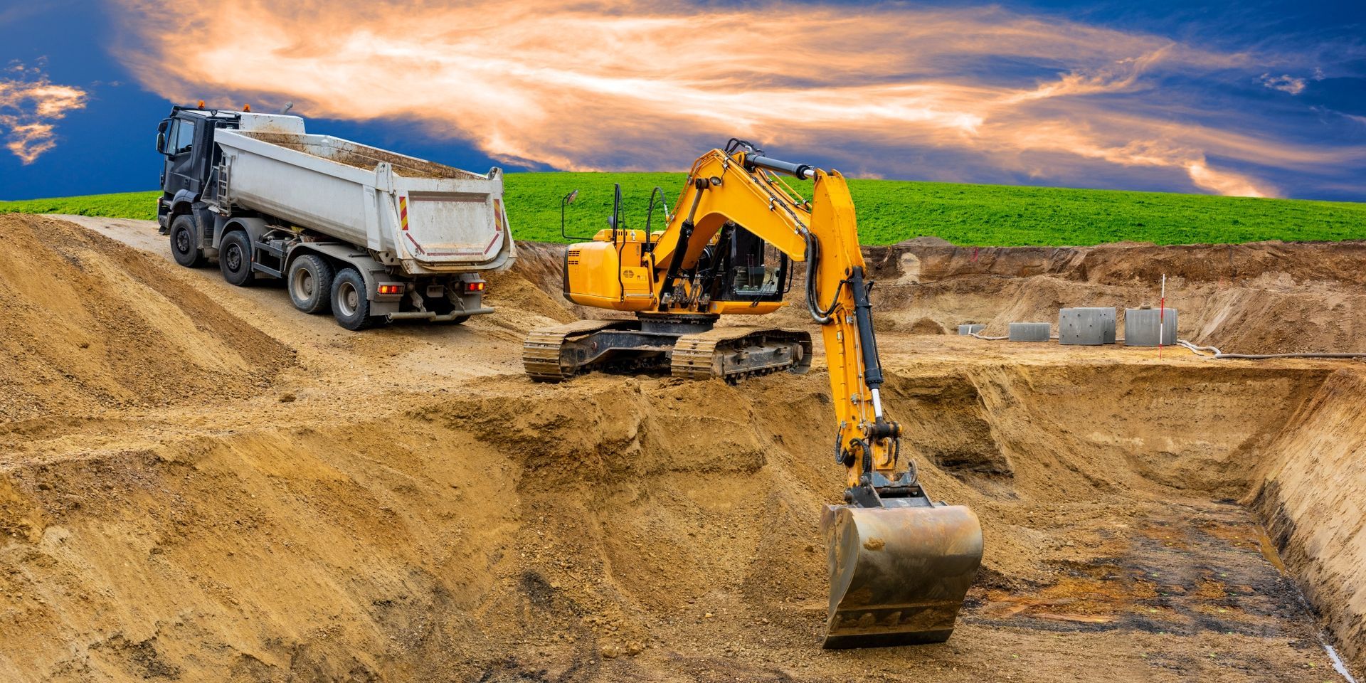 Excavator And Dump Truck at a Sandy Construction — A & S Cuthel Earthmoving & Transport in Bellingen, NSW