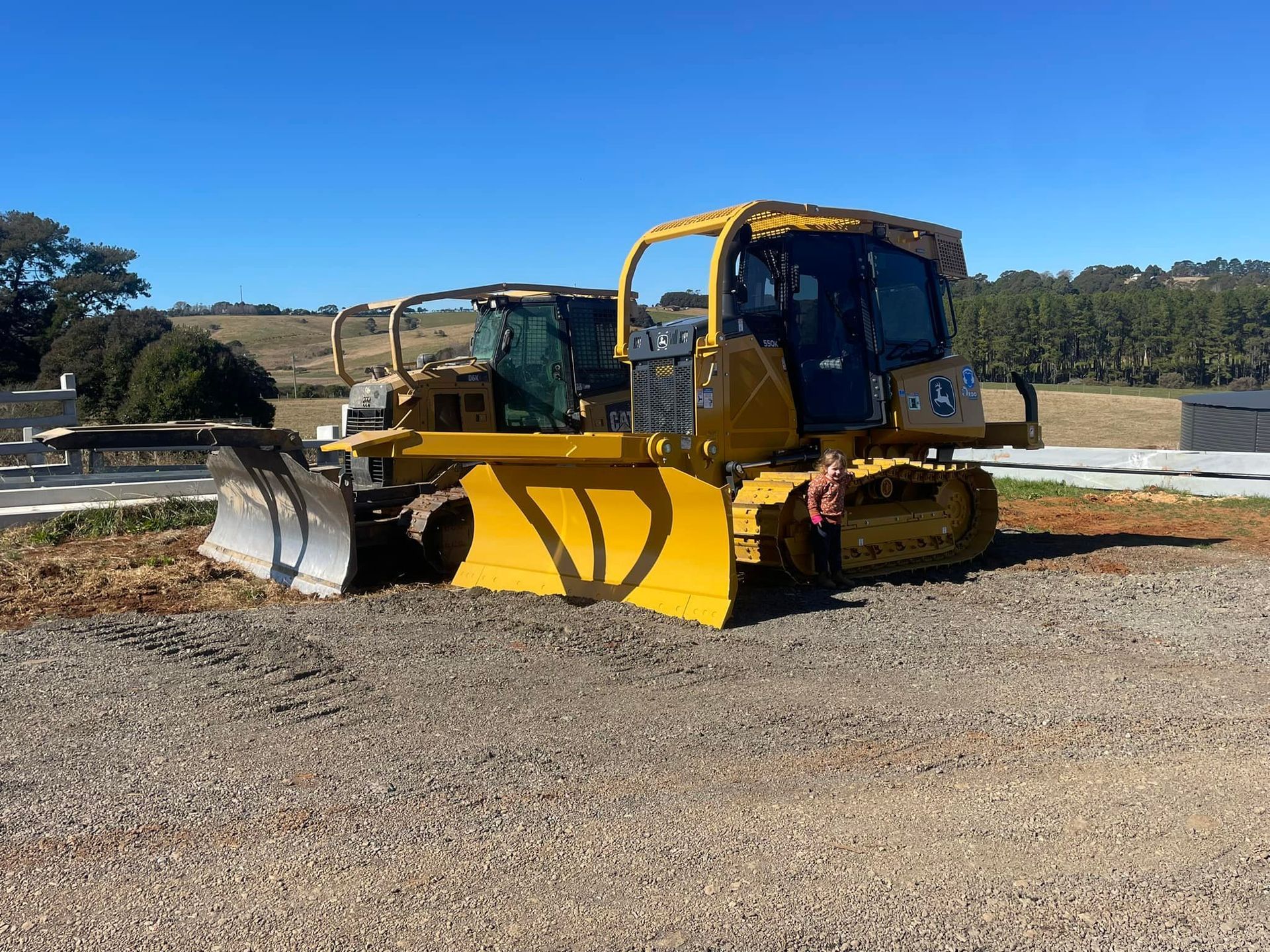 Yellow Bulldozer with Front Blade Parked on A Gravel Lot Outdoors — A & S Cuthel Earthmoving & Transport in Dorrigo, NSW