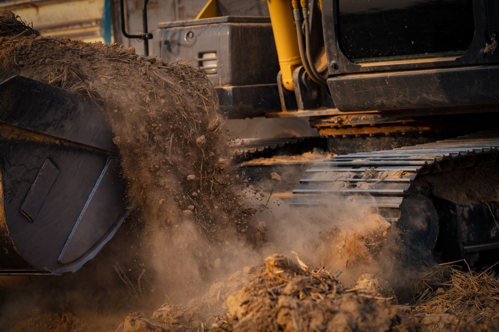 Excavator Bucket Dumping Dirt — A & S Cuthel Earthmoving & Transport in Nambucca Heads, NSW