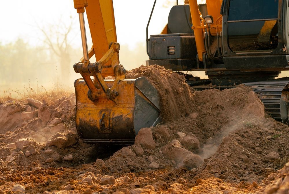 Excavator Bucket Digging Soil — A & S Cuthel Earthmoving & Transport in Dorrigo, NSW