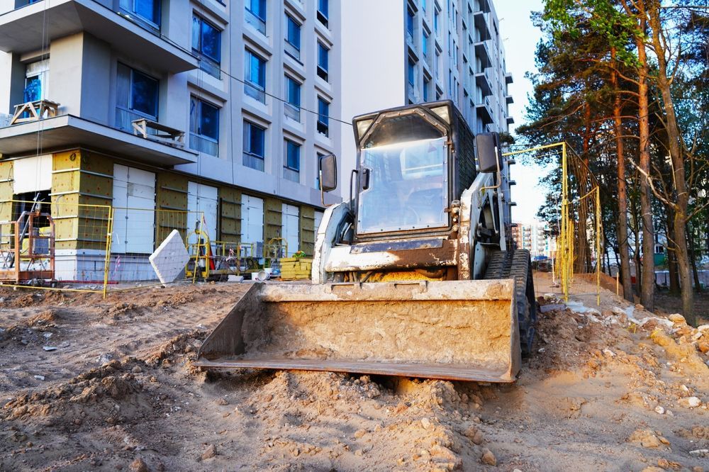Excavator With Raised Bucket — A & S Cuthel Earthmoving & Transport in Dorrigo, NSW