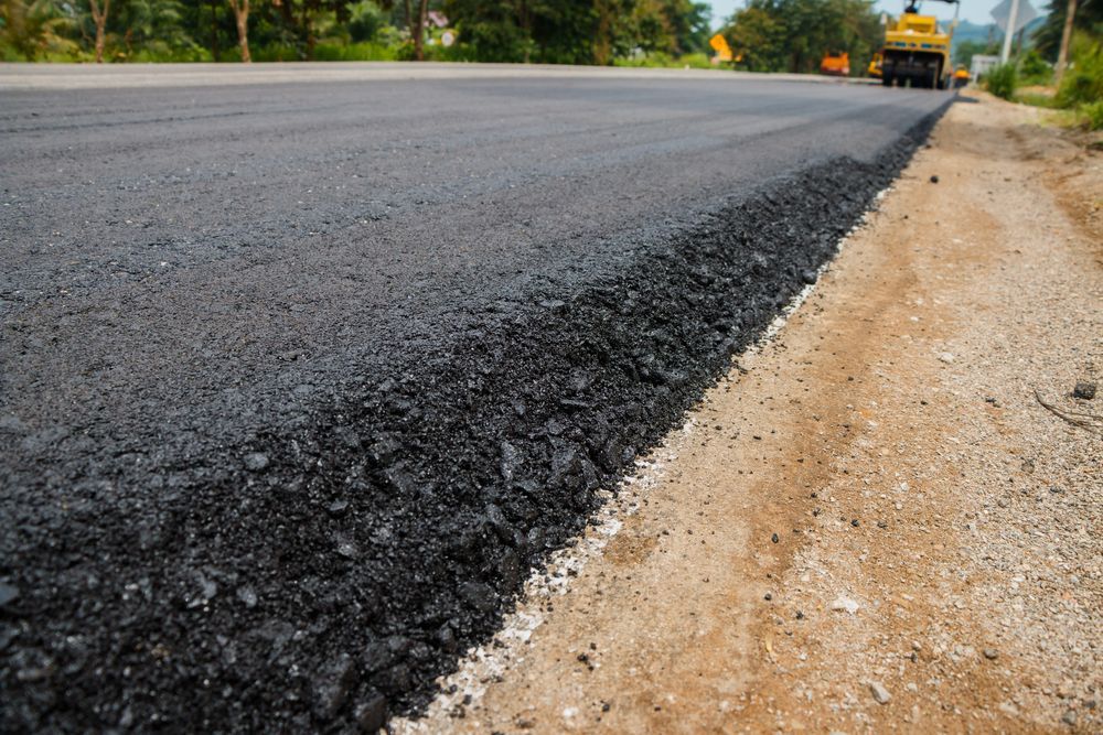 Fresh Asphalt Edge Along a Rural Road — A & S Cuthel Earthmoving & Transport in Nambucca Heads, NSW